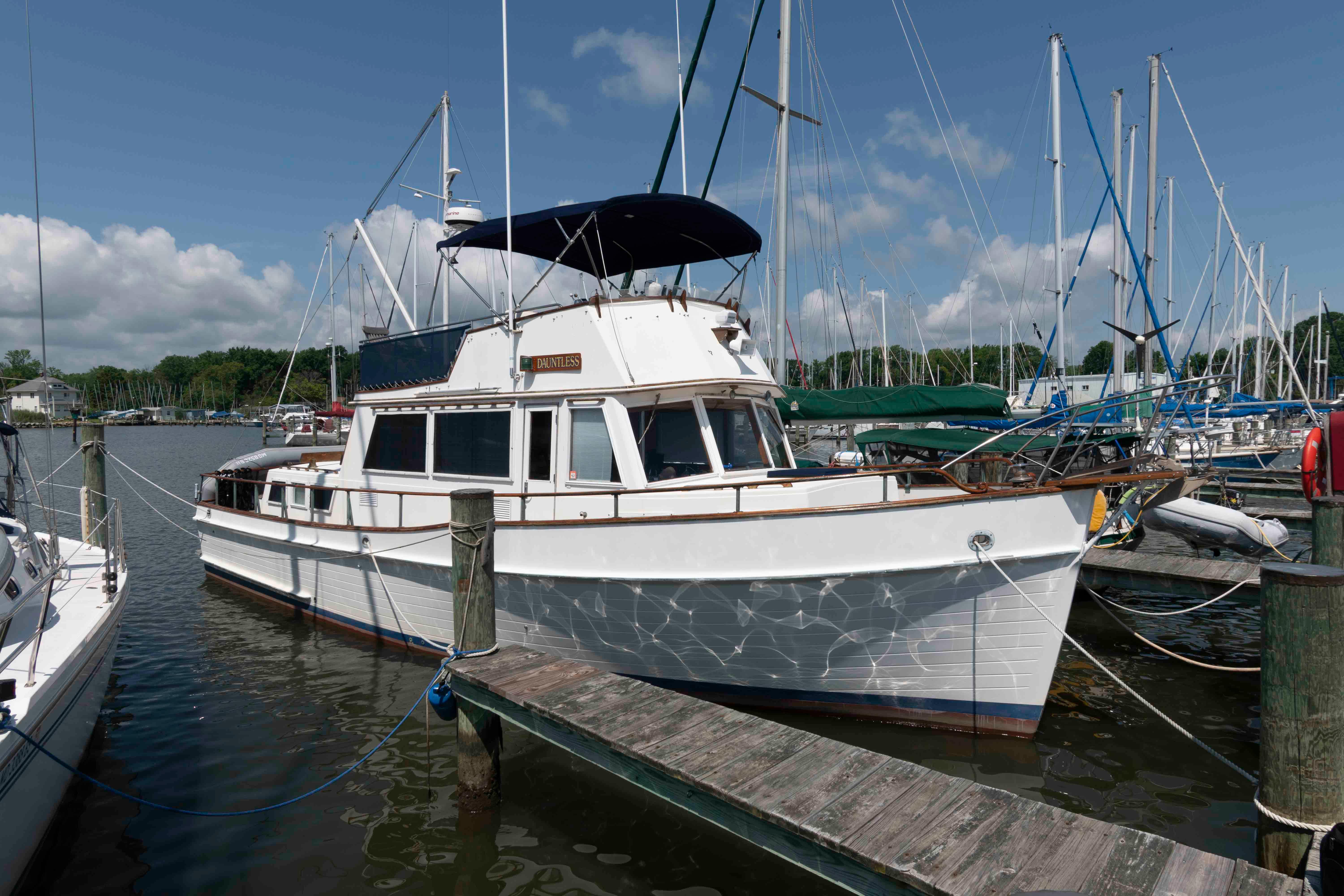 Grand Banks 42 Classic 1983 Grand Banks 42 Classic yacht docked at a marina under a clear blue sky.