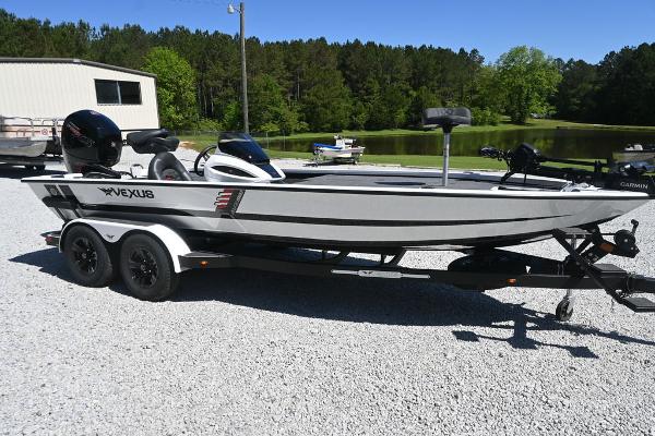 Vexus AVX 1980 2025 Vexus AVX 1980 boat on trailer, parked outdoors near a pond and trees.