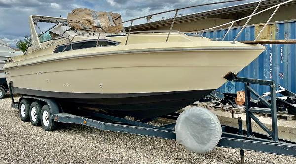 Sea Ray 270 Sundancer 1987 Sea Ray 270 Sundancer boat on trailer, parked outdoors.