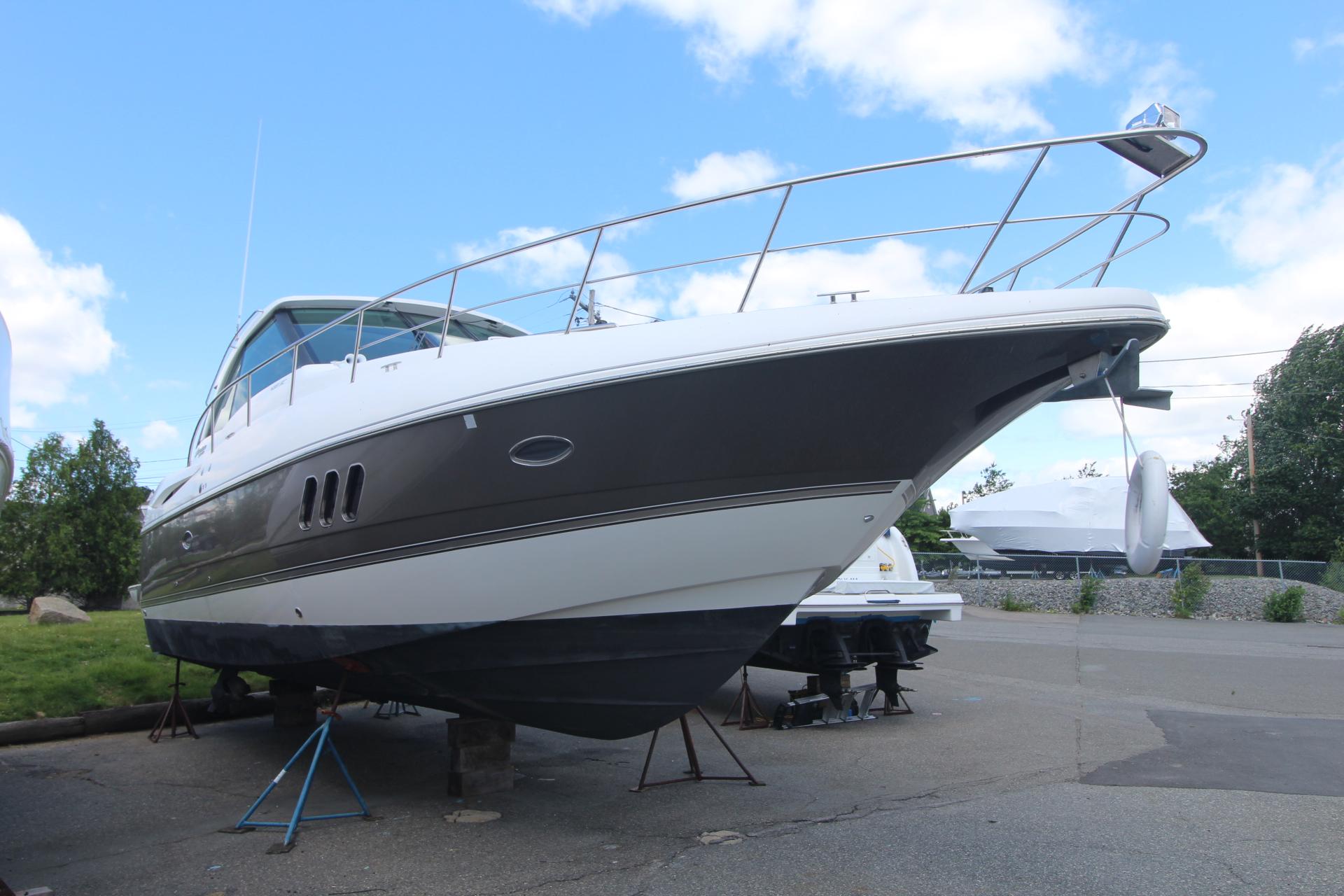 Cruisers Yachts 430 SC 2013 Cruisers Yachts 430 SC on stands, displayed outdoors under a blue sky.