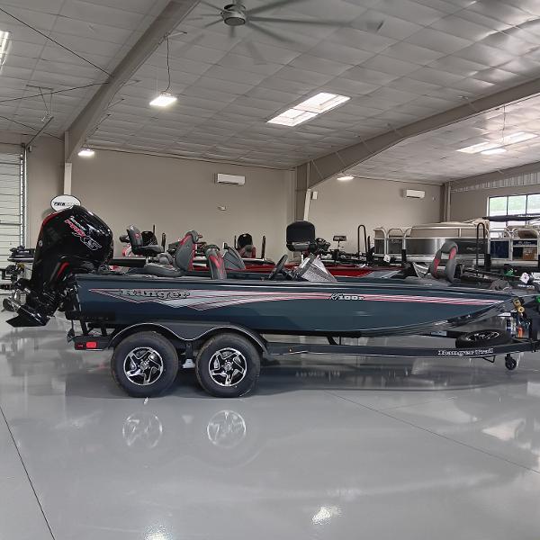 Ranger RT188P 2025 Ranger RT188P boat in showroom, sleek design, dual-axle trailer, modern interior.
