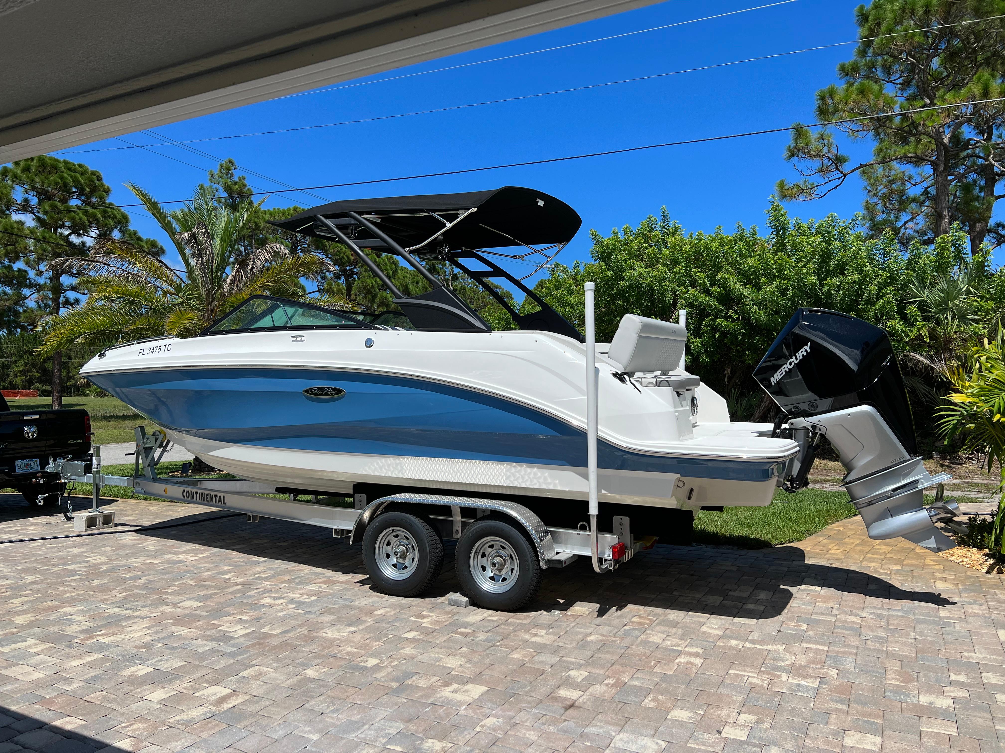 Sea Ray SDX 250 Outboard 2022 Sea Ray 250 SDX-OB boat on trailer, parked outdoors under clear blue sky.