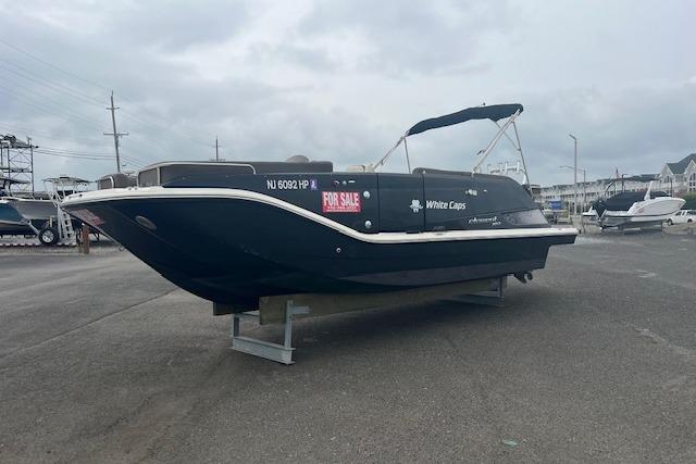 Bayliner Element XR7 2021 Bayliner Element XR7 boat for sale, displayed on a stand in a marina.