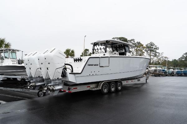 Twin Vee 400 GFX2 CC 2025 Twin Vee 400 GFX2 CC boat on trailer, featuring triple outboard engines.
