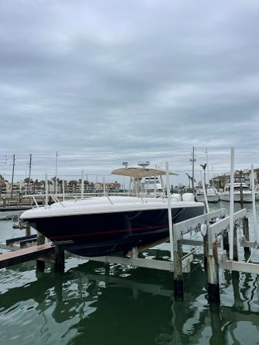 Intrepid 323 Cuddy 2008 Intrepid 323 Cuddy boat docked at marina under cloudy sky.