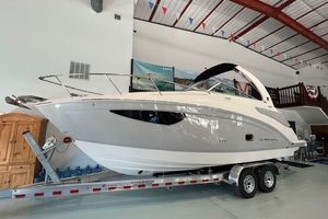 Regal 26 XO 2026 Regal 26 XO boat on trailer in indoor showroom.