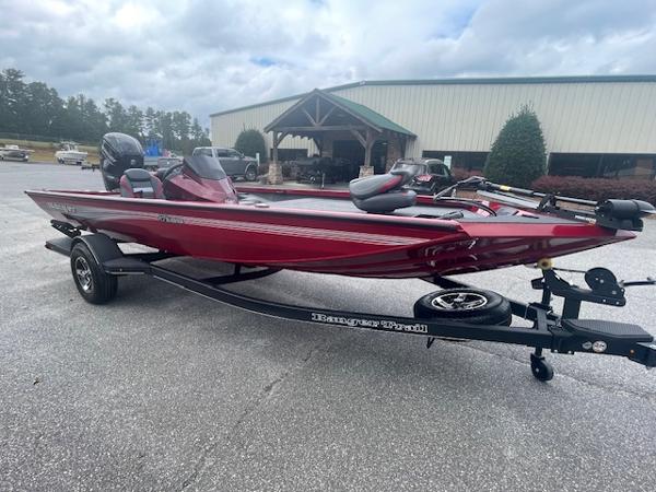 Ranger RT188 2024 Ranger RT188 boat in red on a trailer, parked outdoors.