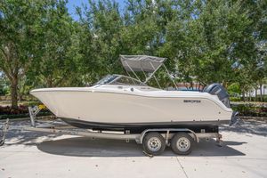 Sea Fox 228 Traveler 2025 Sea Fox 228 Traveler boat on trailer, parked outdoors with trees in background.