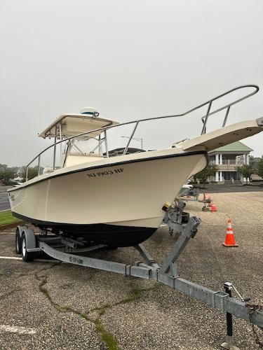 Parker 2300 Deep Vee Center Console 1996 Parker 2300 DV Center Console boat on trailer in parking lot.