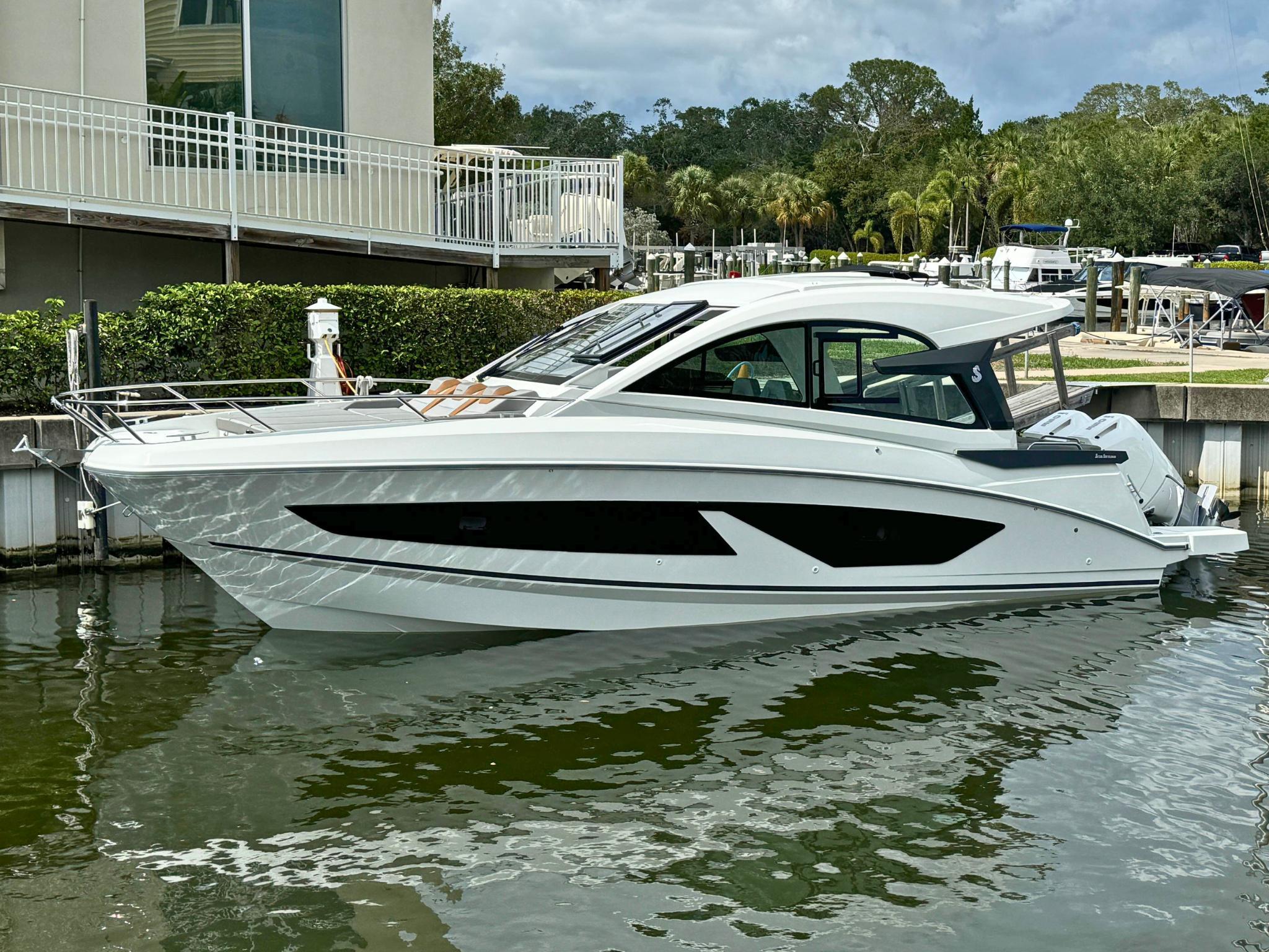 Beneteau Gran Turismo 32 2024 Beneteau Gran Turismo 32 yacht docked in a marina, showcasing sleek design and modern features.