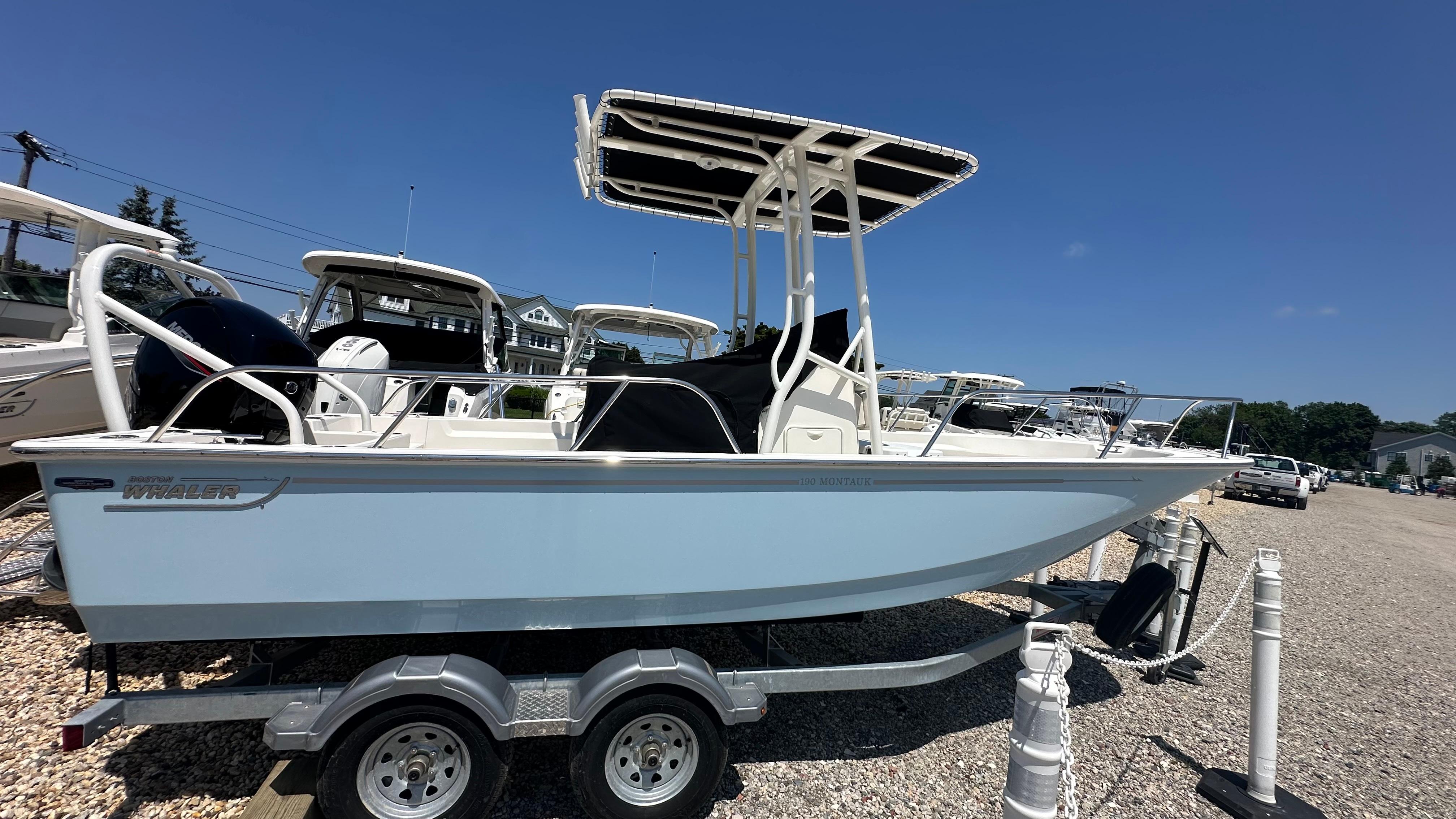 Boston Whaler 190 Montauk 2025 Boston Whaler 190 Montauk boat on trailer under clear blue sky.