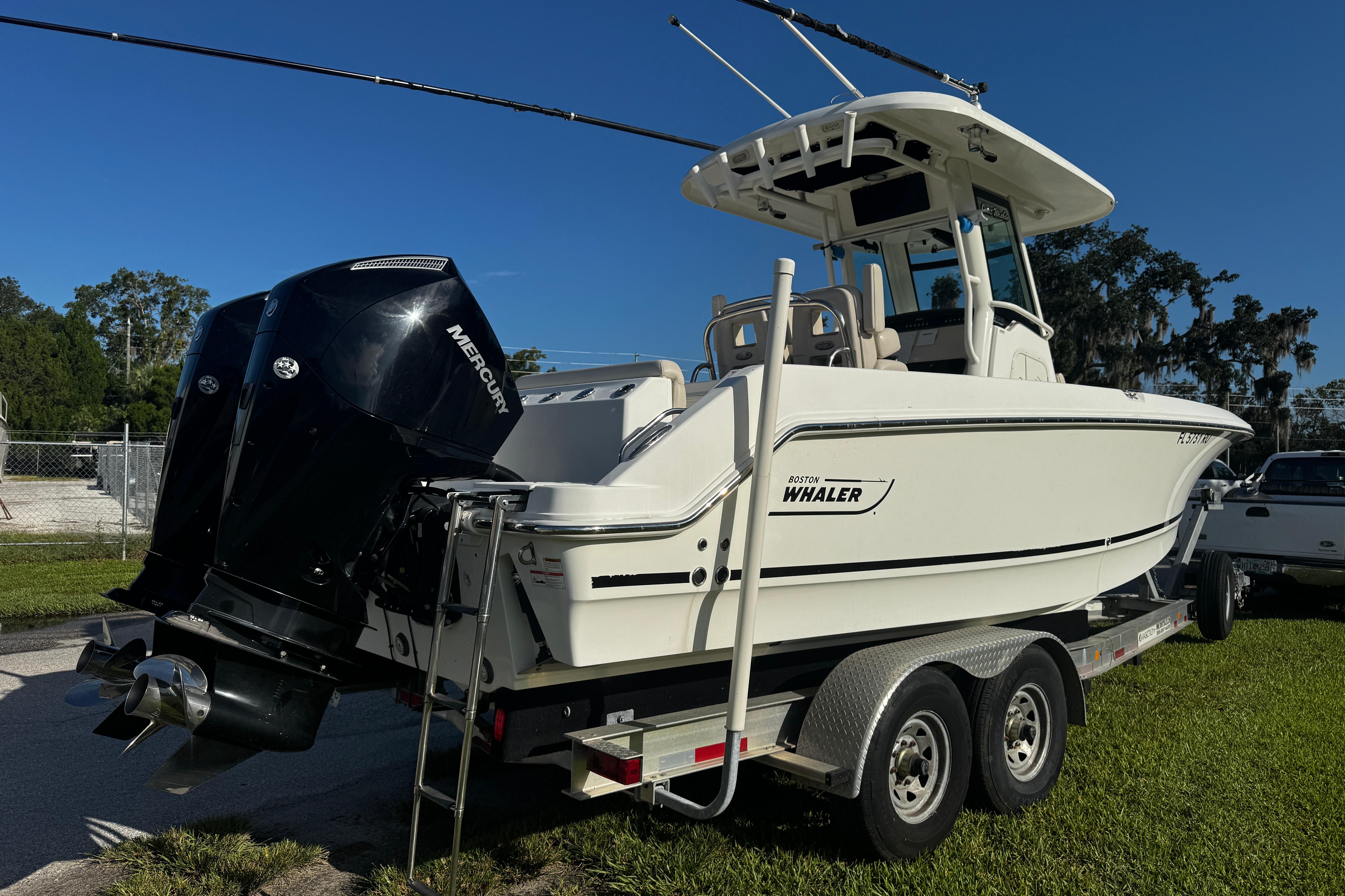 Boston Whaler 26 Outrage 2019 Boston Whaler 26 Outrage boat on trailer, featuring dual Mercury engines.