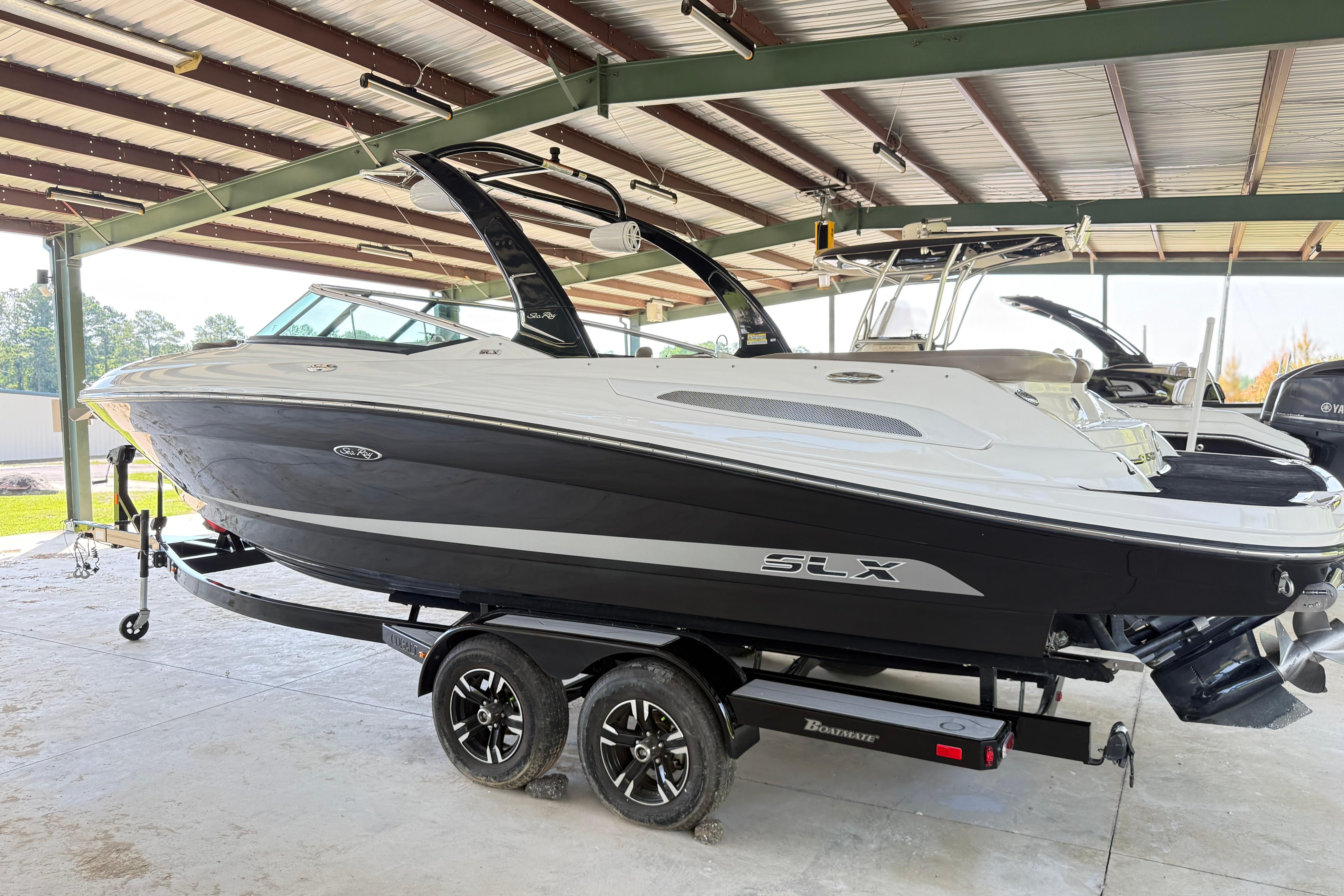 Sea Ray 250 SLX 2013 Sea Ray 250 SLX boat on trailer in covered storage area.