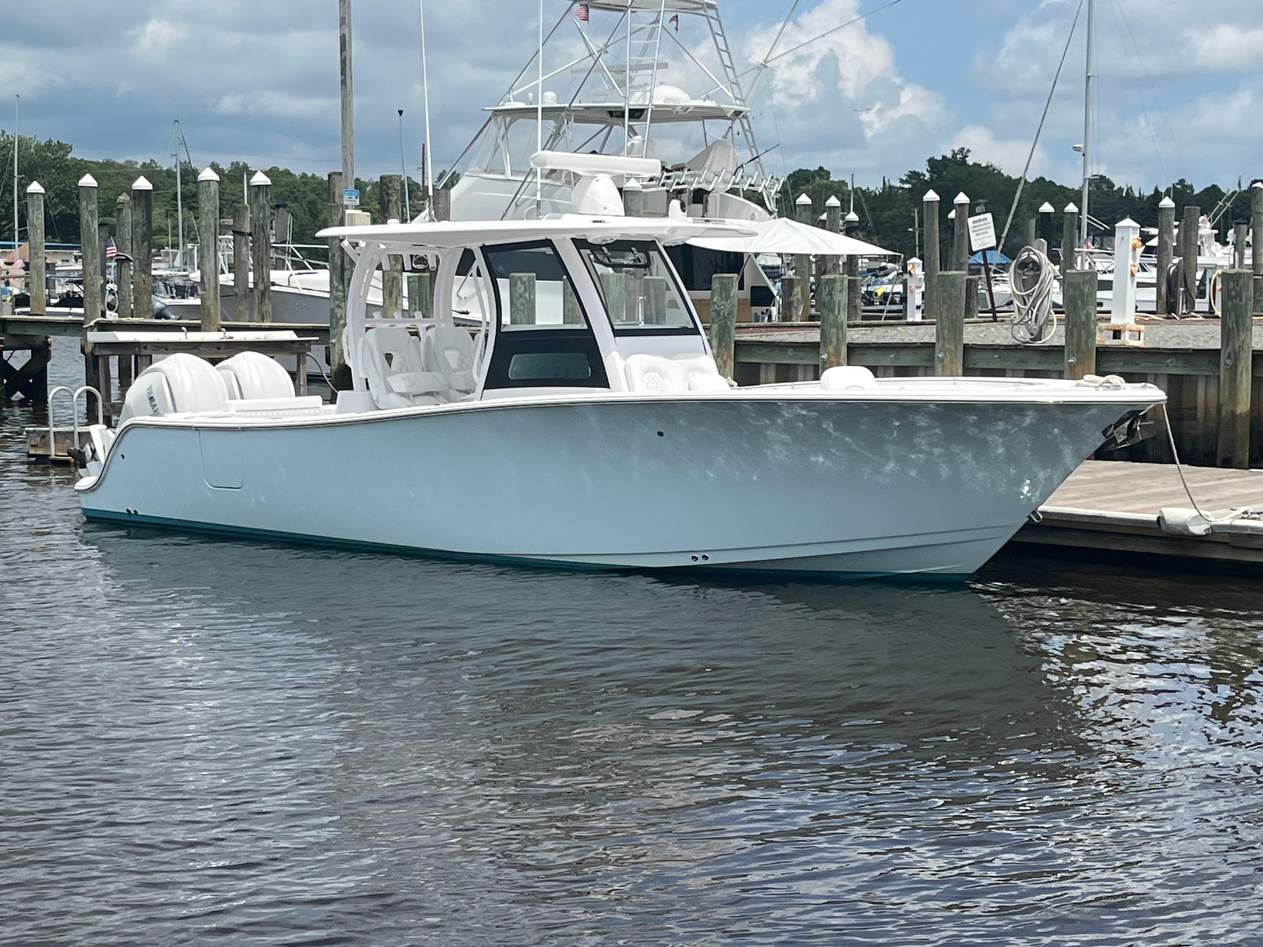 Sportsman Open 302 Center Console 2024 Sportsman Open 302 Center Console boat docked at a marina.