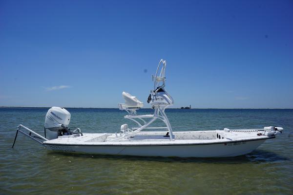 Haynie 23 super cat 2019 Haynie 23 Super Cat boat on calm water under clear blue sky.