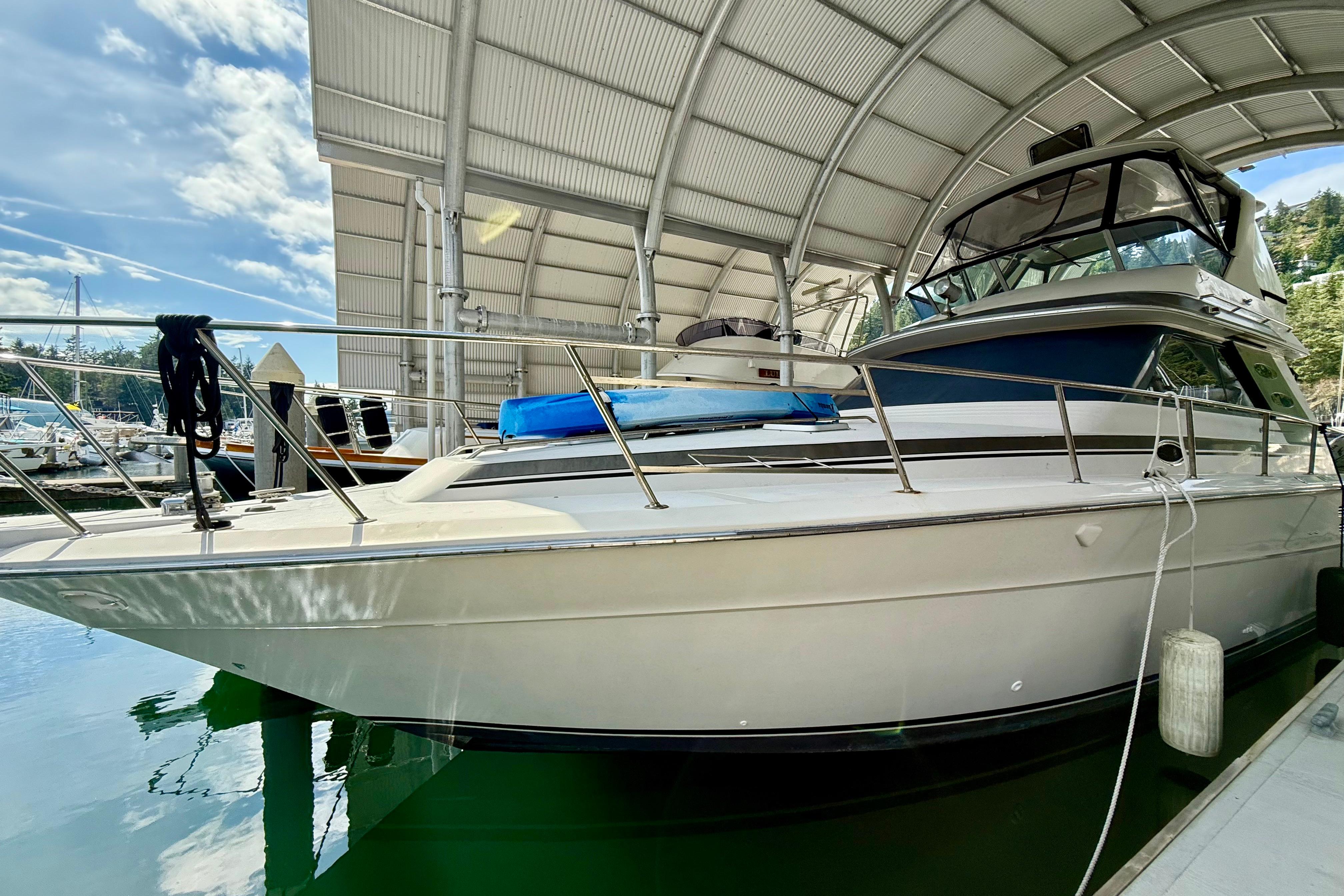 Sea Ray 460 Convertible 1987 Sea Ray 460 Convertible yacht docked under a covered marina.