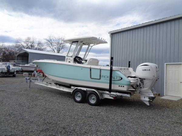 Robalo R250 Center Console 2025 Robalo R250 Center Console boat on trailer near a gray building.