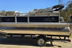 Sun Tracker Bass Buggy 16 XL Select 2026 Sun Tracker Bass Buggy 16 XL Select pontoon boat on trailer.
