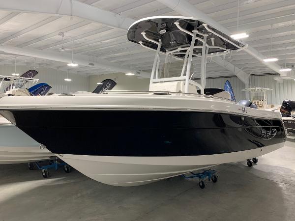 Robalo R222 Explorer 2024 Robalo R222 Explorer boat in showroom, black and white hull, T-top roof.