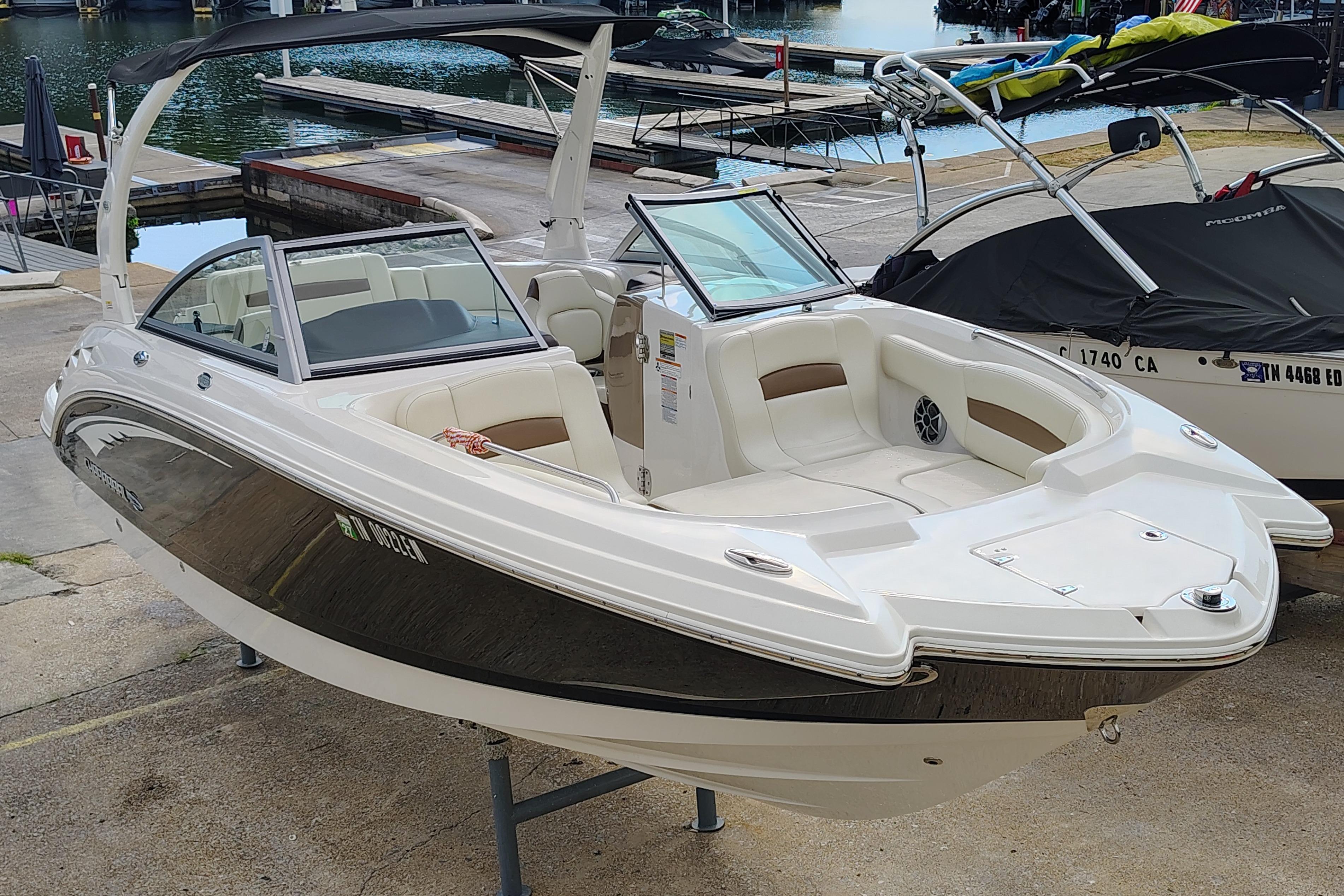 Chaparral 244 Sunesta 2017 Chaparral 244 Sunesta boat docked, showcasing sleek design and spacious seating.