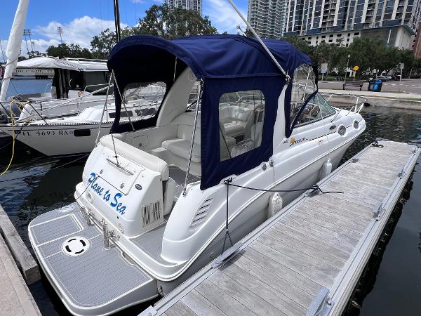 Sea Ray 260 Sundancer 2004 Sea Ray 260 Sundancer docked, featuring blue canopy and sleek white design.