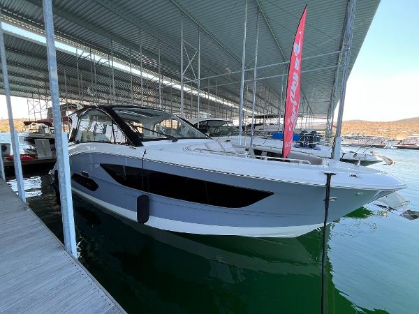 Sea Ray Sundancer 370 Outboard 2025 Sea Ray Sundancer 370 OB docked in a marina under a covered structure.