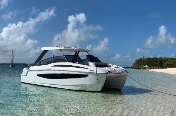Aquila 32 Sport Aquila 32 Sport 2022 yacht anchored on a pristine beach under a clear blue sky.