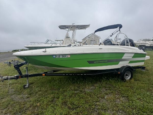Bayliner Element E18 2015 Bayliner Element E18 boat in green and white on a trailer.