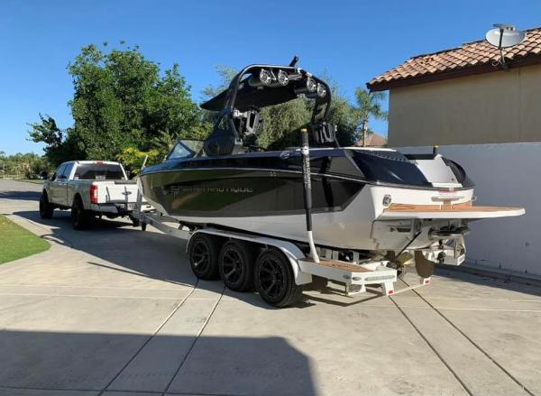 Nautique Super Air Nautique G25 2019 Nautique Super Air Nautique G25 boat on trailer, hitched to a white truck.