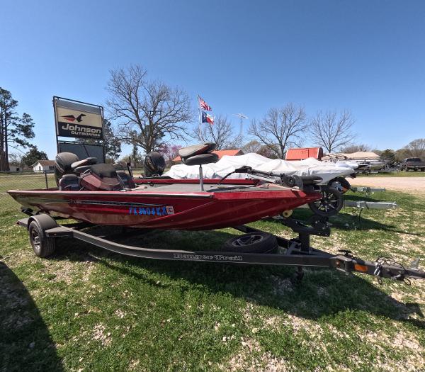 Ranger RT188 2023 Ranger RT188 boat on trailer, displayed outdoors under clear sky.