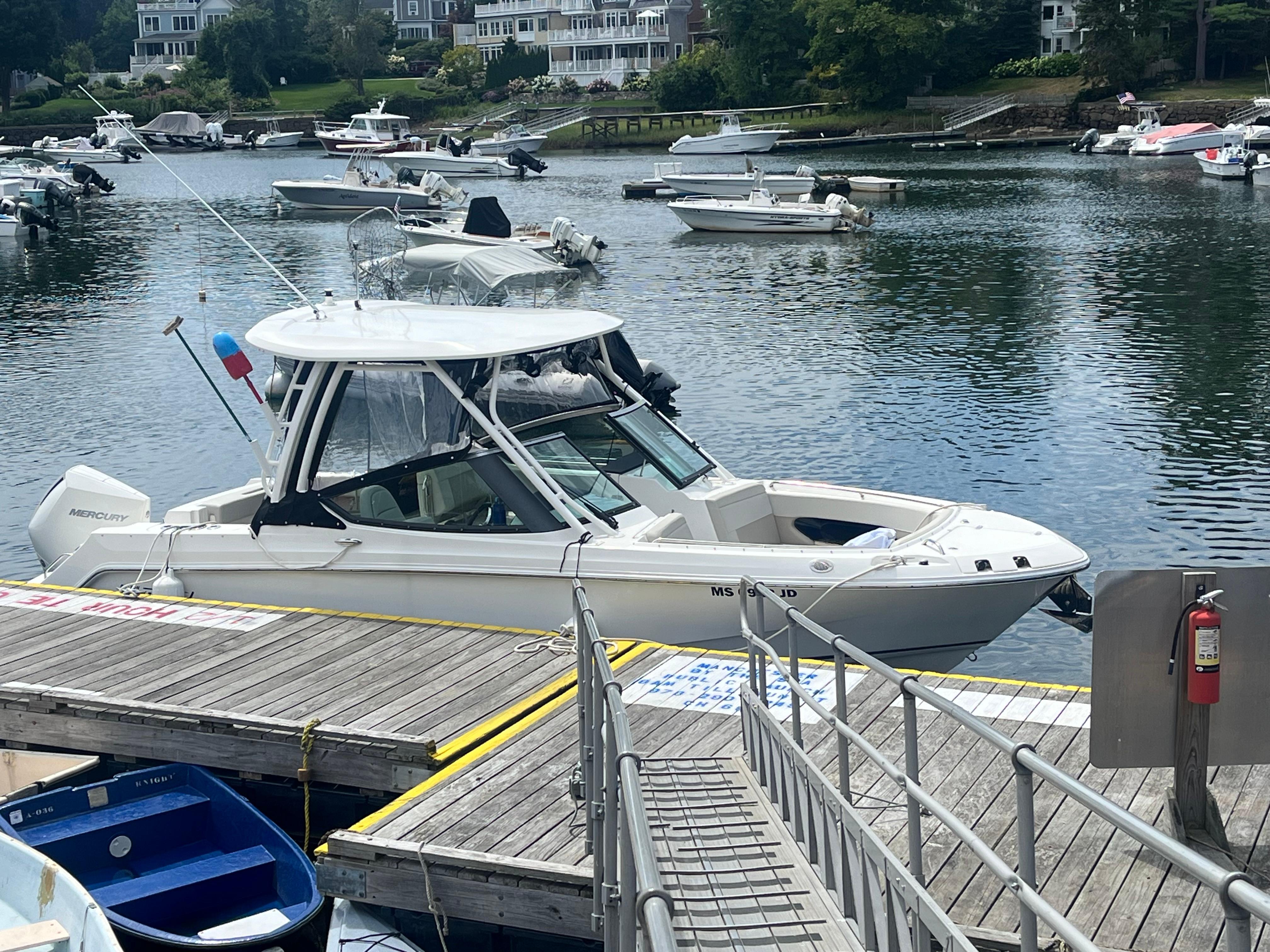 Boston Whaler 240 Vantage 2023 Boston Whaler 240 Vantage docked at a marina with other boats.