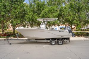 Sea Fox 228 Commander 2025 Sea Fox 228 Commander boat on trailer, parked outdoors with trees in background.