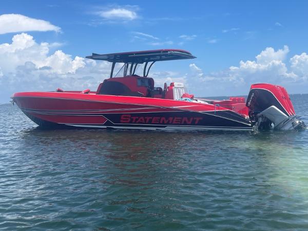 Statement 350 Open Red 2024 Statement 350 Open boat on water under blue sky.