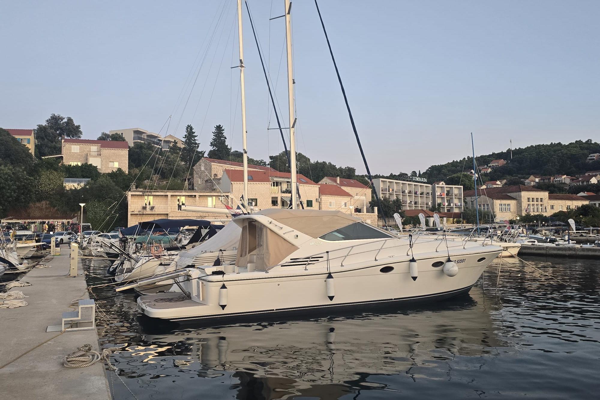 Uniesse 42 Open 2003 Uniesse 42 Open yacht docked in a scenic marina setting.