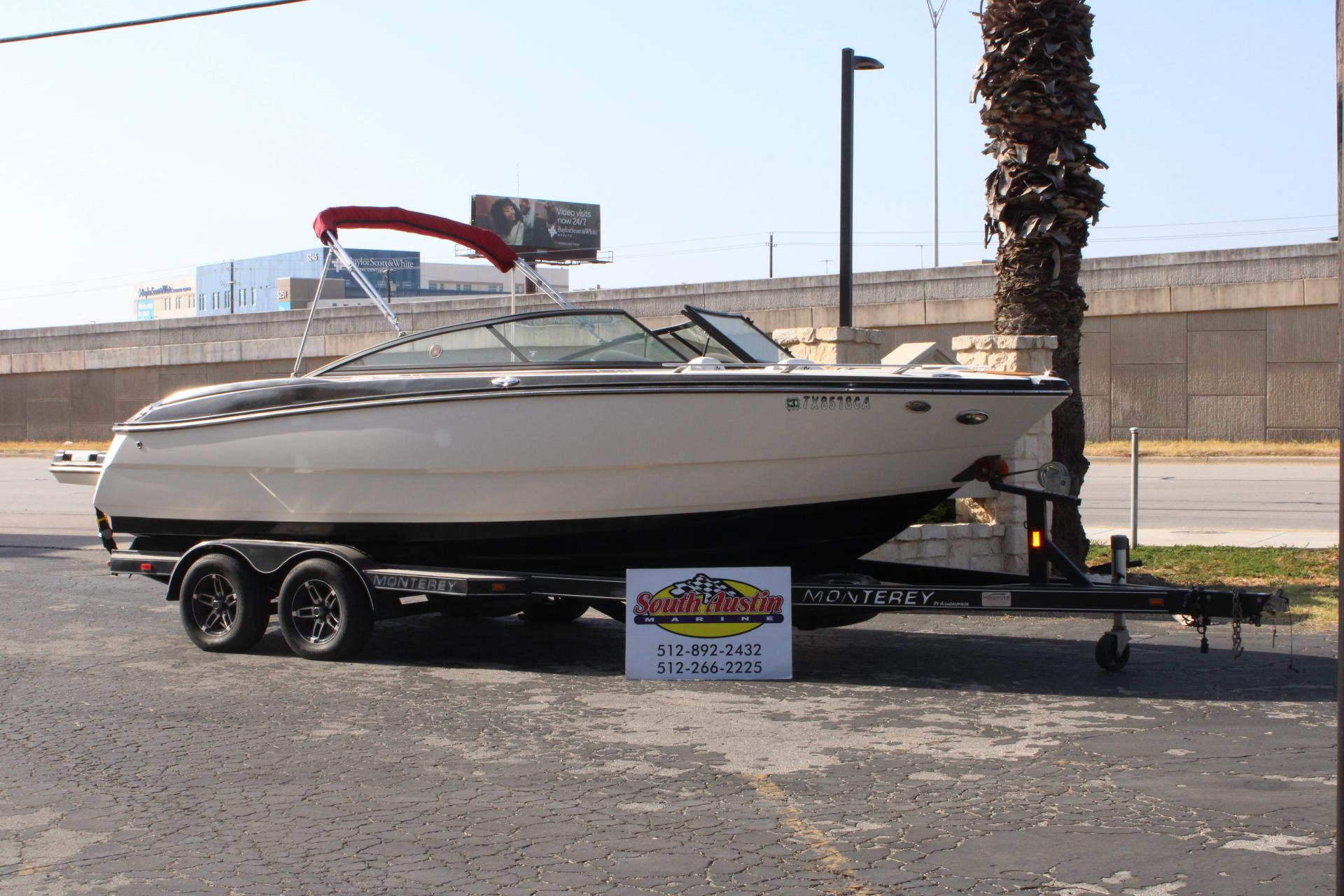 Monterey 234 SS 2013 Monterey 234 SS boat on trailer, parked outdoors near palm tree.