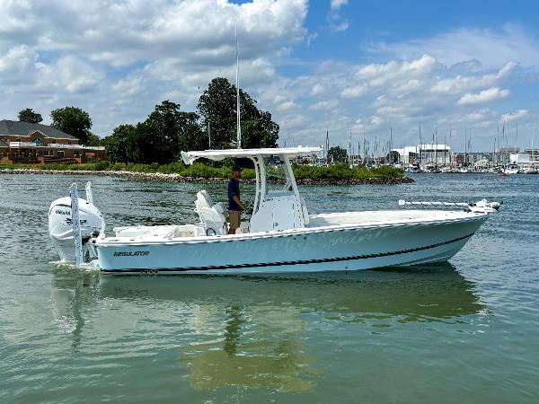 Regulator 26XO 2025 Regulator 26XO boat on calm water, clear sky, marina background.