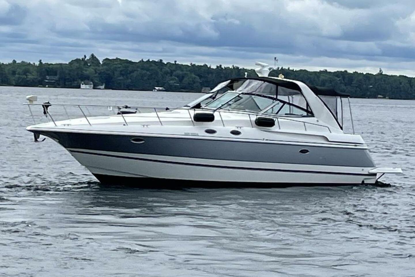 Cruisers Yachts 3870 2001 Cruisers Yachts 3870 on a lake with cloudy skies in the background.