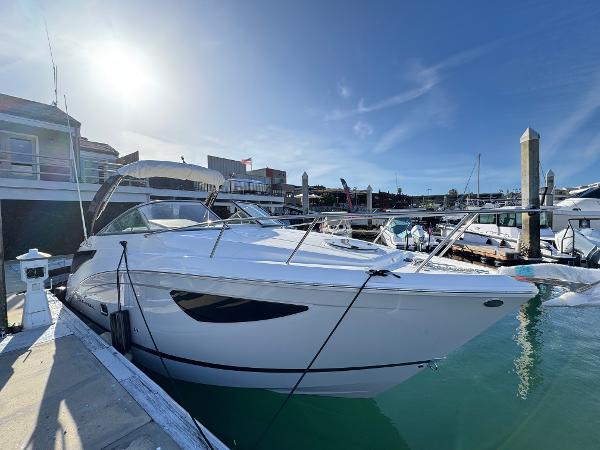 Regal 26 XO 2025 Regal 26 XO boat docked in a sunny marina setting.