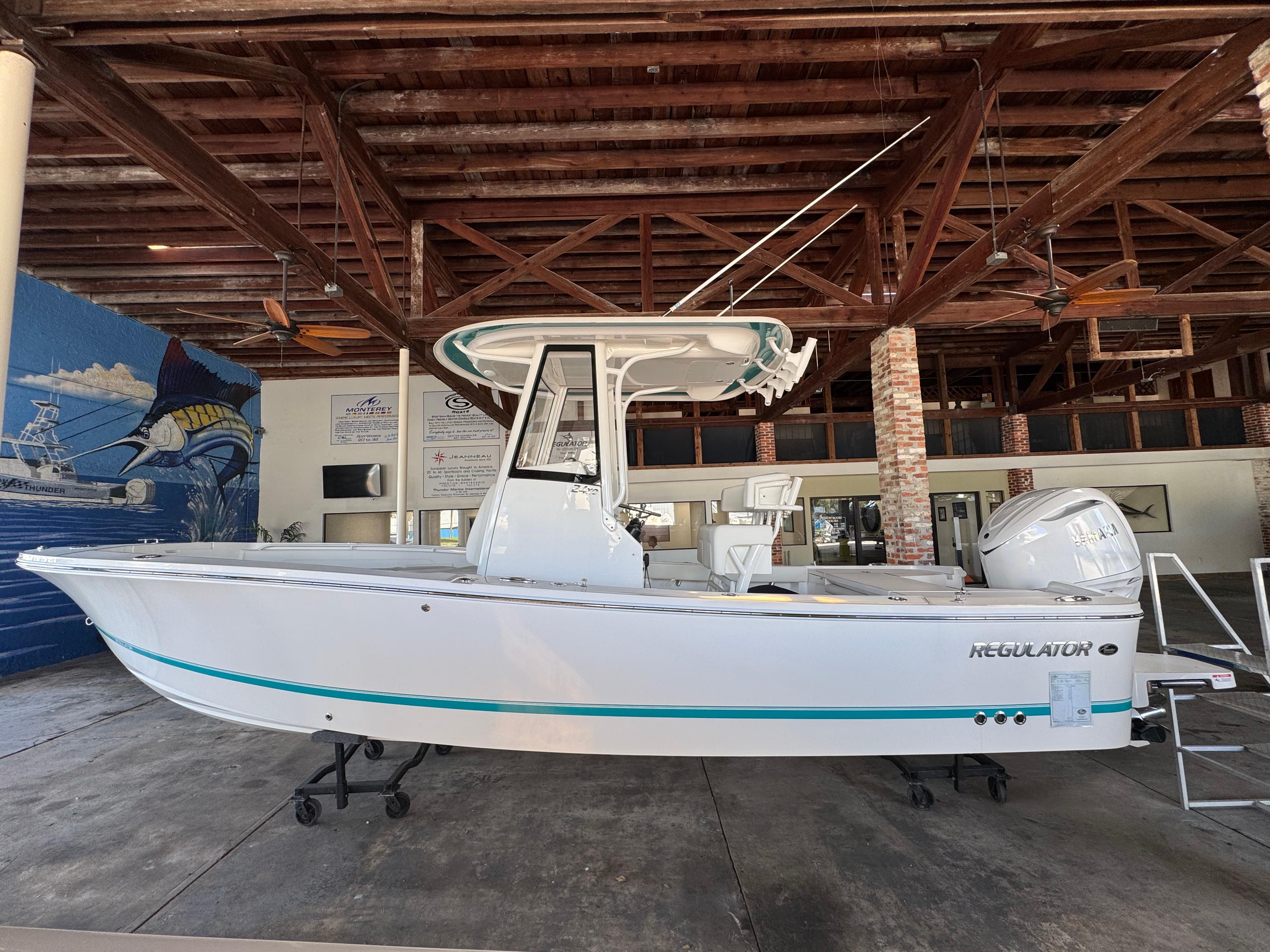 Regulator 24 XO 2025 Regulator 24 XO boat displayed indoors with wooden ceiling backdrop.
