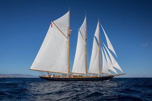 Classic Townsend & Downey Schooner Classic 1902 Townsend & Downey Schooner sailing on open sea under clear blue sky.