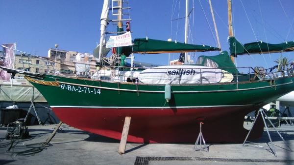 Formosa 36 1980 Formosa 36 sailboat on dry dock, green hull, red bottom, urban background.