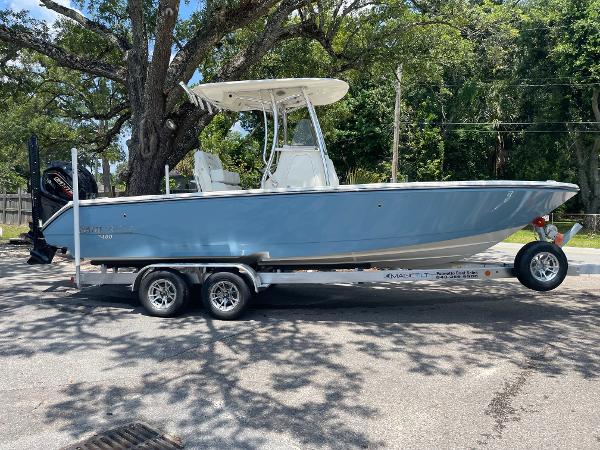Pathfinder 2400 TRS 2024 Pathfinder 2400 TRS boat on trailer, parked under trees.
