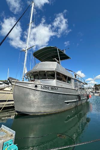 Custom Carlson Marine Trawler Custom 2002 Carlson Marine Trawler "Lone Wolf" docked under clear blue sky.