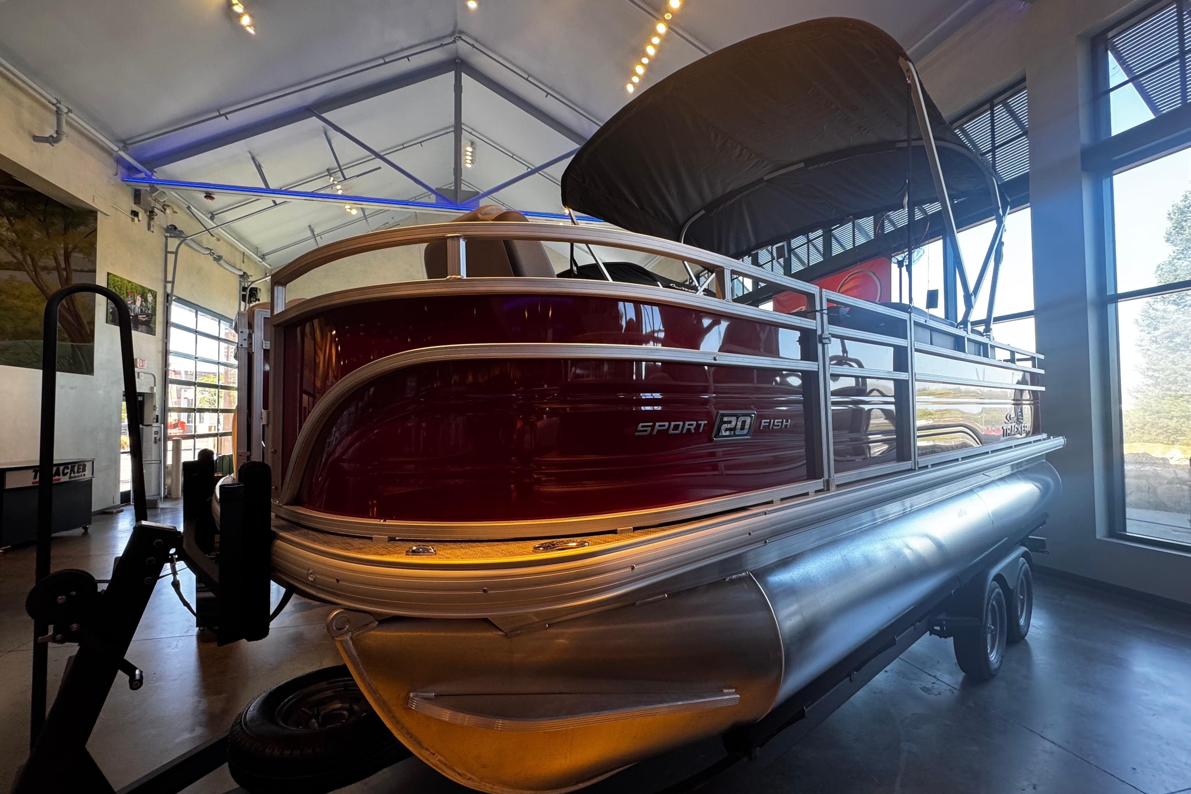 Sun Tracker SportFish 20 DLX 2026 Sun Tracker SportFish 20 DLX pontoon boat displayed indoors.