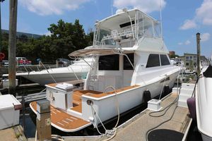 Viking 50 Convertible 1991 Viking 50 Convertible yacht docked at marina, featuring spacious deck and flybridge.