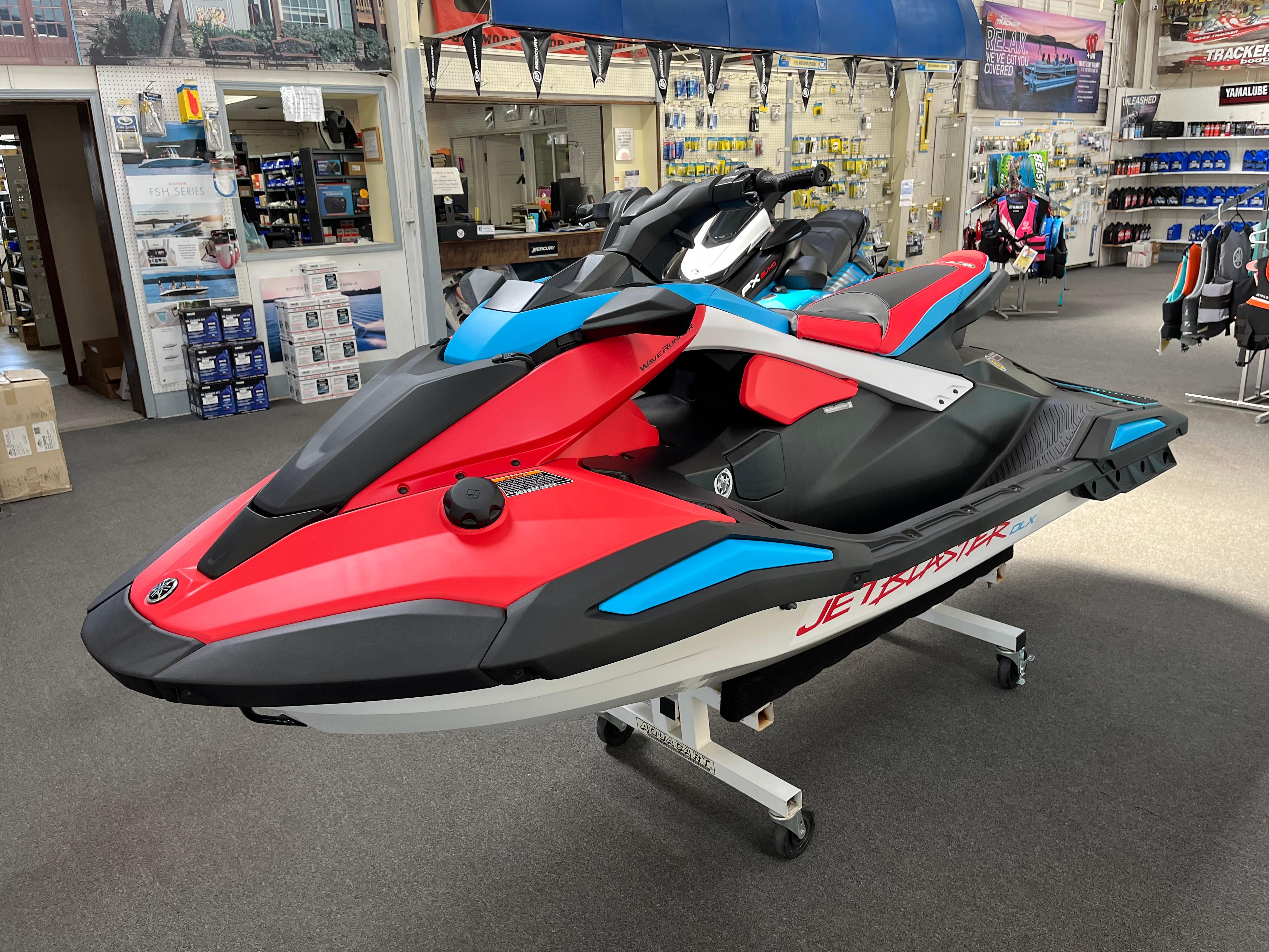 Yamaha WaveRunner JetBlaster DLX 3-Up 2025 Yamaha WaveRunner JetBlaster DLX 3-Up in showroom, vibrant red and blue design.