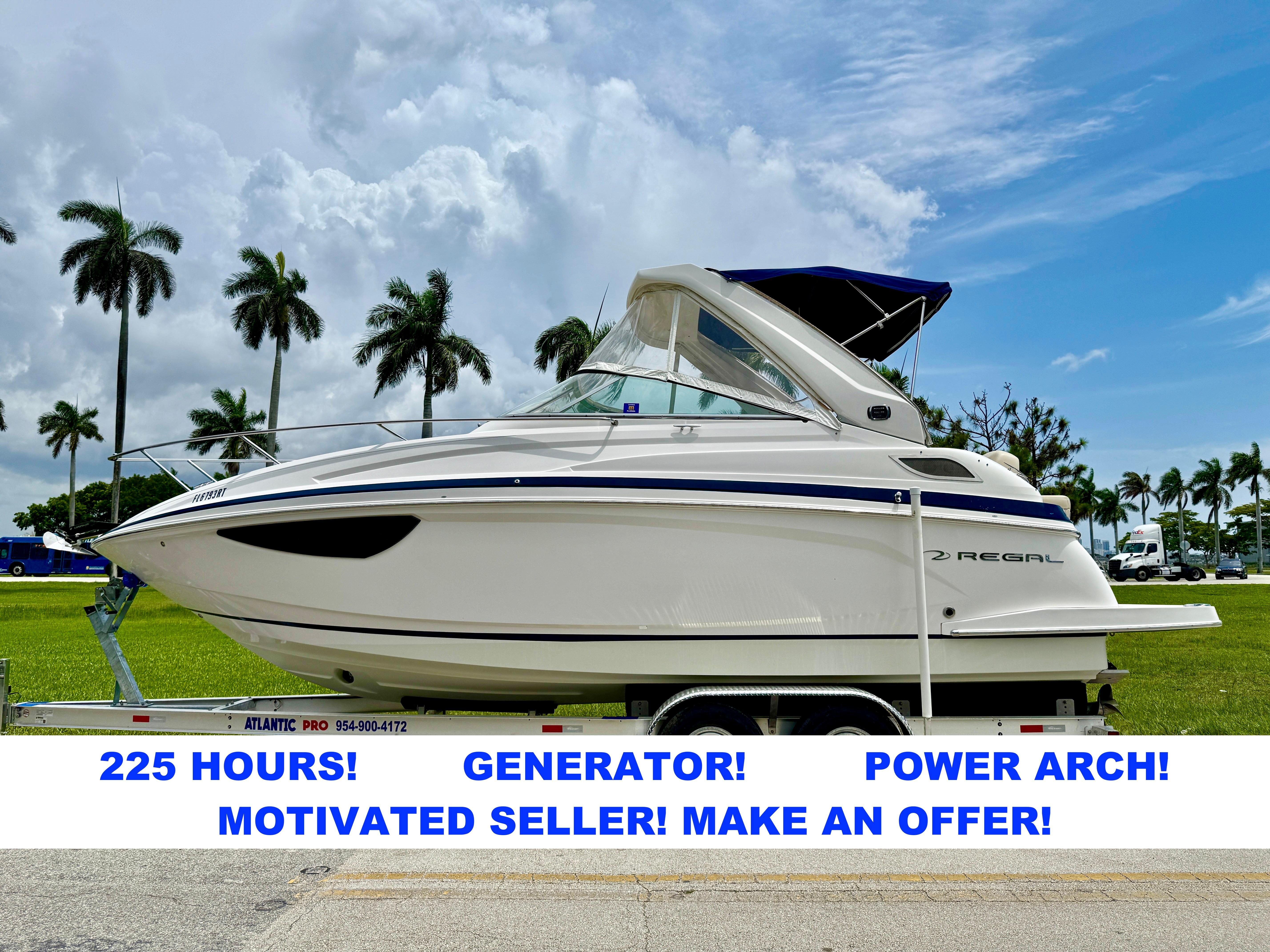 Regal 28 Express 2019 Regal 28 Express boat on trailer, palm trees in background, for sale with 225 hours.