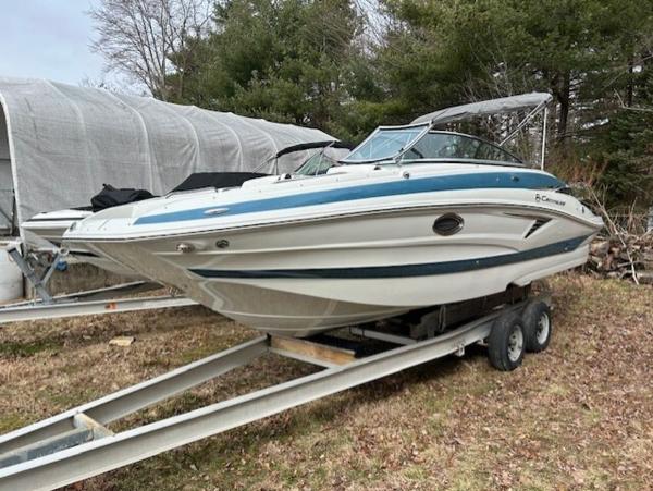 Crownline E235 2024 Crownline E Series E235 boat on trailer in outdoor storage.