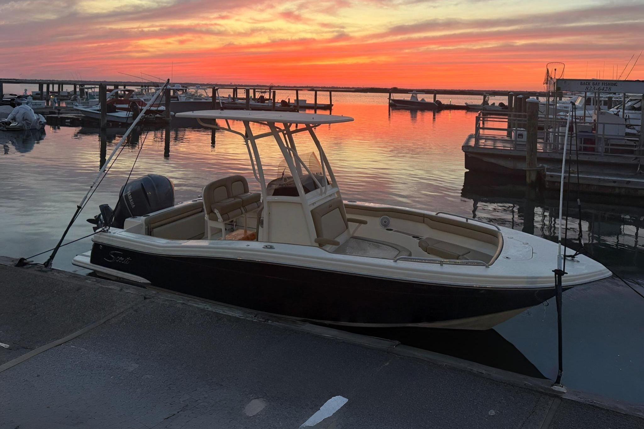 Scout 215 XSF 2018 Scout 215 XSF boat docked at sunset with vibrant sky.