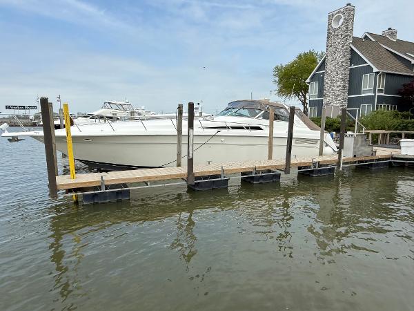 Sea Ray 50 1992 Sea Ray 50 yacht docked beside a waterfront house.